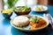 paneer butter masala with rice on a banana leaf