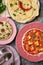Paneer Makhani, Jeera Rice and paratha in pink plate on dark background
