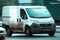 panel van Fiat Ducato 130 Multijet speeding on road. White dirty delivery van in motion on the street, side view