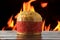 Panettone, decorative food, on wooden table, fire in the background