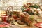 Panettone, raisins and candied fruit cubes on wooden cutting board with christmas ornaments