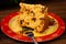 Panettone slice of fruit topped with chestnuts on a table decorated for Christmas