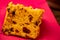 Panettone slice of fruit topped with chestnuts on a table decorated for Christmas