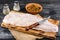 Pangasius fillet on a wooden cutting board with spices and knife on a black wooden background