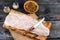 Pangasius fillet on a wooden cutting board with spices and knife on a black wooden background