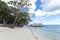 Panglao, Bohol, Philippines - Tourists arrive at Alona Beach via a large outrigger boat. Relatively empty beach