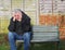 Panic attack man crying on a bench.