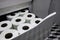 Panic buying toilet paper in bulk during pandemic isolation. Closeup view of a pile of paper rolls in the bathroom at home of