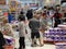 Panicked shoppers grabbing toilet paper off the pallet