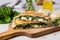 panini sandwich with spinach and cheese on a marble table