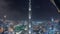 Paniramic skyline view of Dubai downtown with mall, fountains and Burj Khalifa aerial night timelapse