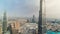 Paniramic skyline view of Dubai downtown with mall, fountains and Burj Khalifa aerial timelapse