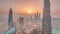 Paniramic skyline view of Dubai downtown during sunrise with mall, fountains and Burj Khalifa aerial morning timelapse