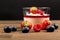 Pannacotta with Berries on table, side view, custard and Jelly, Wood and black background.