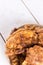 Panned pork steaks on the plate above wooden board background.