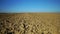 Panned shot of plowed field and blue sky