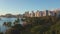 Panning aerial drone slowly flying over a colorful Honolulu Skyline while Sunset in Oahu, Hawaii with Waikiki Beach