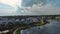 panning aerial footage of beachfront homes along the Atlantic coast, blue ocean water, cars driving on the street