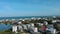 panning aerial footage of beachfront homes along the Atlantic coast, blue ocean water, cars driving on the street