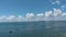 Panning aerial footage of the blue ocean water in the Miami South Channel with boats and ships sailing, skyscrapers and hotels