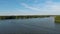 panning aerial footage of the rippling waters of Lake Acworth with a motorboat pulling a water skier