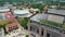 panning aerial footage of Tiger Stadium, buildings and lush green trees and grass on the campus of Louisiana State University