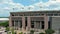 panning aerial footage of Tiger Stadium, buildings and lush green trees and grass on the campus of Louisiana State University