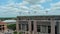 panning aerial footage of Tiger Stadium, buildings and lush green trees and grass on the campus of Louisiana State University