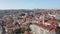 Panning aerial view of town in sunny day. Rooftop view from flying drone. Lisbon, capital of Portugal.