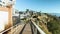 panning footage along the footpath at Dana Point Bluff Top Trail with hotels, blue ocean water and boats and yachts docked