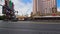 panning footage along Las Vegas Blvd with the Treasure Island Hotel, the Mirage, cars driving, blue sky and clouds in Las Vegas