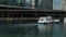 panning footage of a beautiful autumn landscape along the Chicago River with boats sailing on the water, skyscrapers