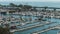 panning footage of the boats and yachts docked in the Dana Point Harbor with vast blue ocean water and lush green trees