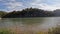 panning footage of a motorboat sailing along the Tennessee River in a gorgeous autumn landscape with autumn trees