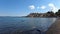 Panning right at Bracciano lake with many birds swimming in clean water and beautiful ancient skyline of medieval village of Angui