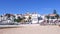 Panning of sandy Praia do Ribeiro and boats on bay a a sunny day