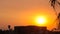 Panning Shot of Beautiful Sunset Over a Building and Palm Trees