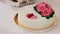 A panning shot of a beautiful wedding cake with heart decorations.