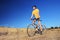 Panning shot of a bicycle rider riding a mountain bike outdoors