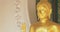 Panning shot of golden Buddhist statue