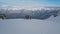 Panning shot group of active sports people with snowboarding and skiing standing on top of mountain