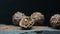 Panning shot of group chocolate sweet candy, bonbons on stone with black background