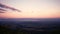 Panning shot of the mountain and colorful sky scenery at dusk from view point.