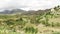 Panning shot over typical Madagascar landscape in region near Mahatsanda. Rice fields and clay houses on distatn hills, some corn