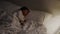 panning shot of toddler baby sleeping on bed at night