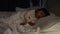 panning shot of toddler baby sleeping on bed at night