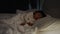 panning shot of toddler baby sleeping on bed at night