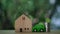Panning and slow motion of wood home model, stack coins and toy car