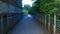 Panning to creepy dark alley sidewalk underneath overpass