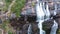 Panning up to reveal water cascading down into a pool at MacKenzie Falls